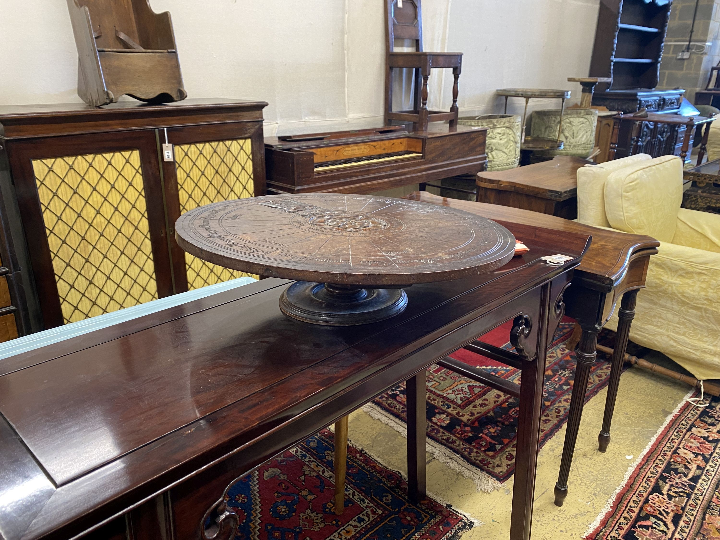 An early 20th century carved oak lazy Susan modelled on King Arthur’s round table, diameter 55cm, height 14cm